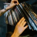 Music Industry - Close-up of Woman Looking through Records on a Shelf