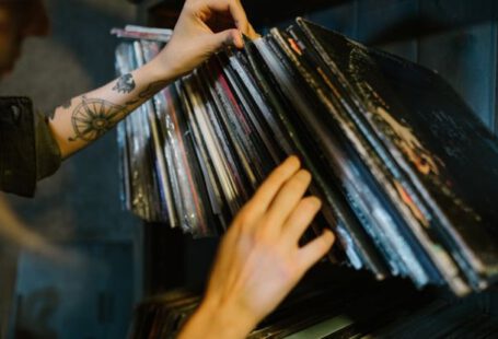 Music Industry - Close-up of Woman Looking through Records on a Shelf