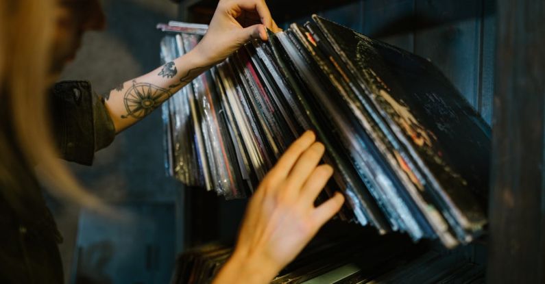 Music Industry - Close-up of Woman Looking through Records on a Shelf