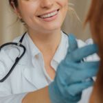 Vaccinations - A Woman in White Long Sleeve Shirt Smiling