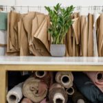 Lifestyle Choices - Rolls of assorted fabrics and textiles and sewing patterns inside tailor atelier