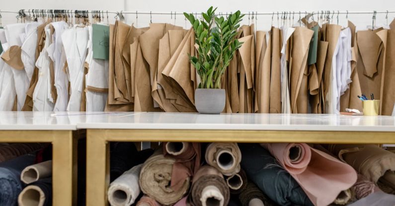 Lifestyle Choices - Rolls of assorted fabrics and textiles and sewing patterns inside tailor atelier