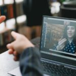 Language Preservation - Young lady learning sign language during online lesson with female tutor