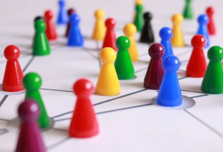 Teams - Close Up Photography of Yellow Green Red and Brown Plastic Cones on White Lined Surface