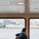 Travel Trends - A man sitting in a chair on a boat