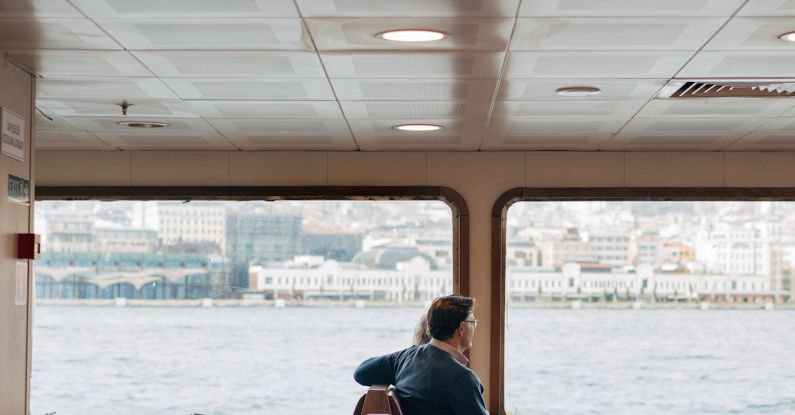 Travel Trends - A man sitting in a chair on a boat