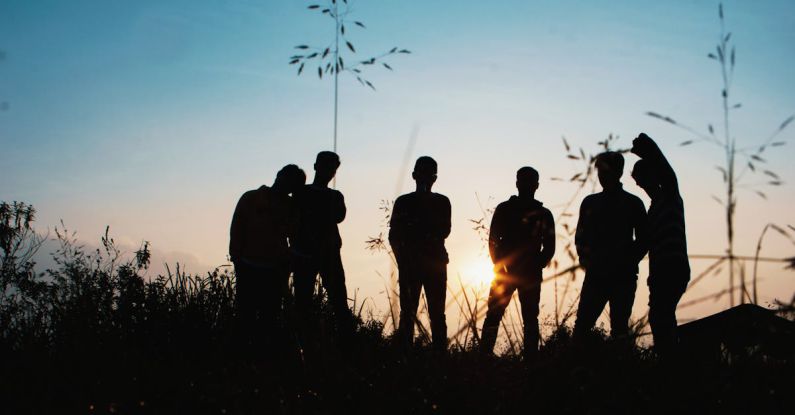 Youth - Silhouette Group of People Standing on Grass Field