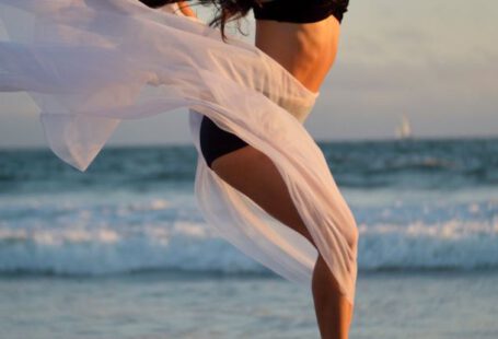 Agile Methodologies - Skinny dancer jumping over sandy shore of ocean