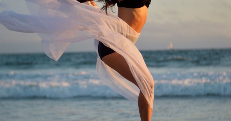 Agile Methodologies - Skinny dancer jumping over sandy shore of ocean
